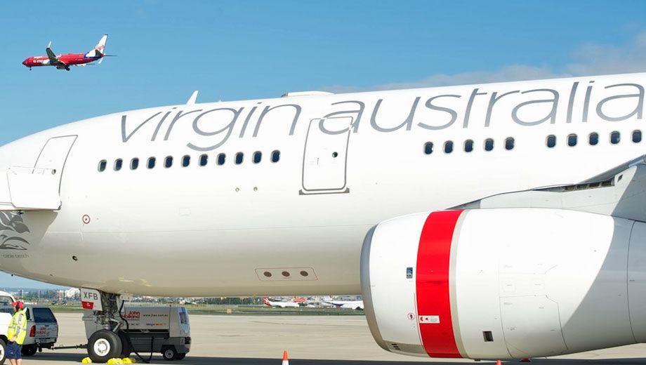 Virgin Australia takes off as Virgin Blue comes in for a final approach.