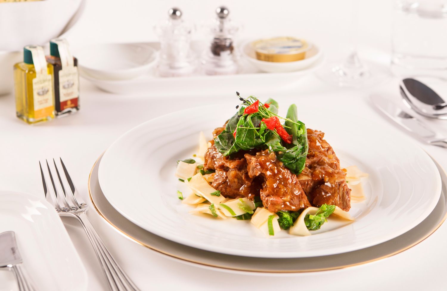 This first class main course of 'stockyard Asian braised beef cheek' sees the beef slow-braised in Asian master stock, served with stir-fried rice noodles and kai-lan.