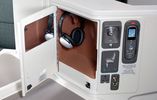 This cubby (located behind the seat's 'cocktail table') contains a vanity mirror and noise-cancelling headphones... 