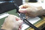 An employee makes final adjustments to a Zenith El Primero wristwatch.