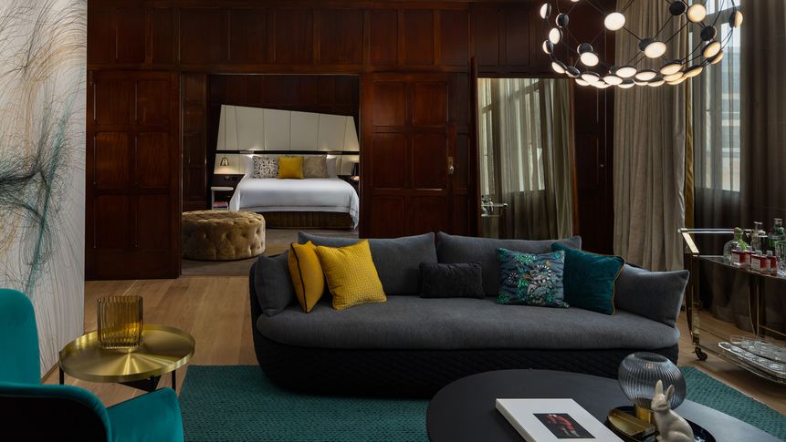 The QT State Suite features separate lounge and dining areas, plus its own balcony.