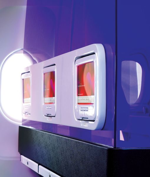 No dowdy divider curtains in Virgin America planes, just glossy purple perspex.