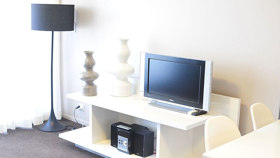 There's a medium-sized TV and a mini hifi system in the room.