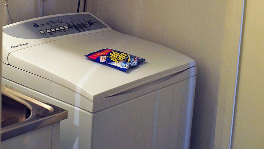 The laundry is hidden away in a bathroom cupboard with a full size waching machine, dryer and laundry tub -- and a convenience sachet of soap.