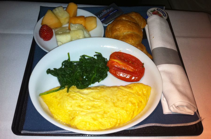 Breakfast: ham and cheese omelette, greens,fruit and a croissant