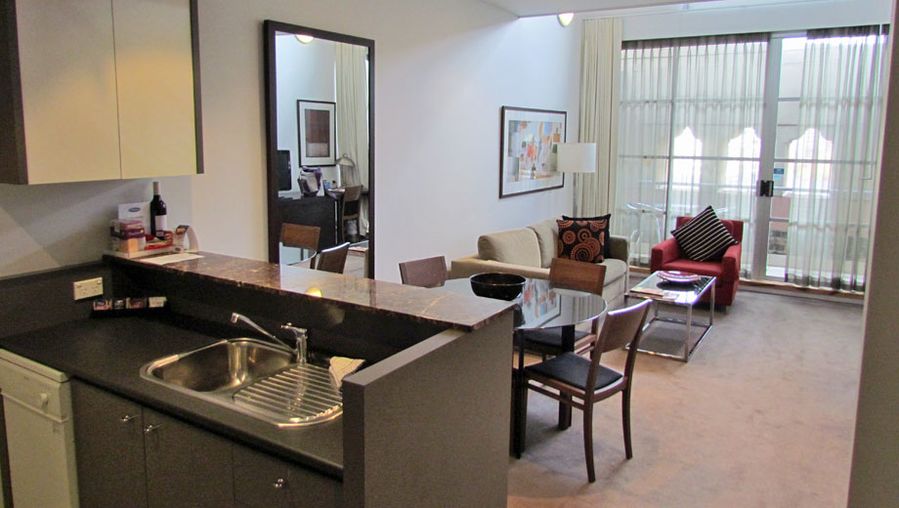 The room is spacious, with a kitchen and living area all in one.