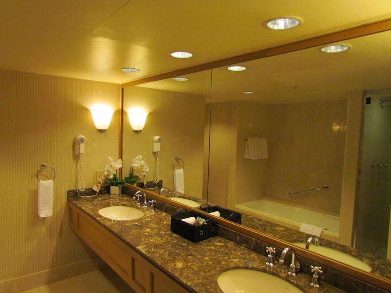 The spacious bathroom has double sinks and generous amounts of toiletries.