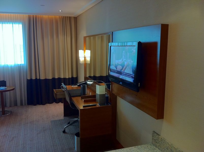 The large TV and excellent desk setup round out the room.