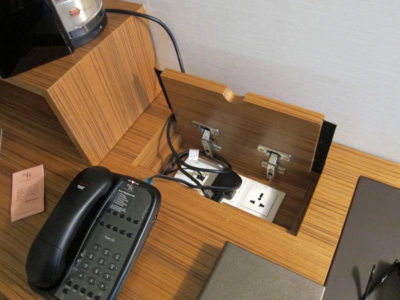 A universal power point is hidden neatly away in a trap door drawer.