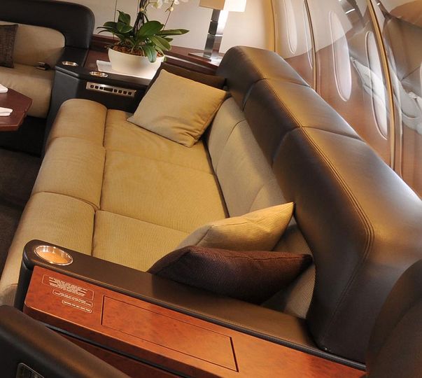 The massive couch/sofa bed, is large enough to fit at least three people.