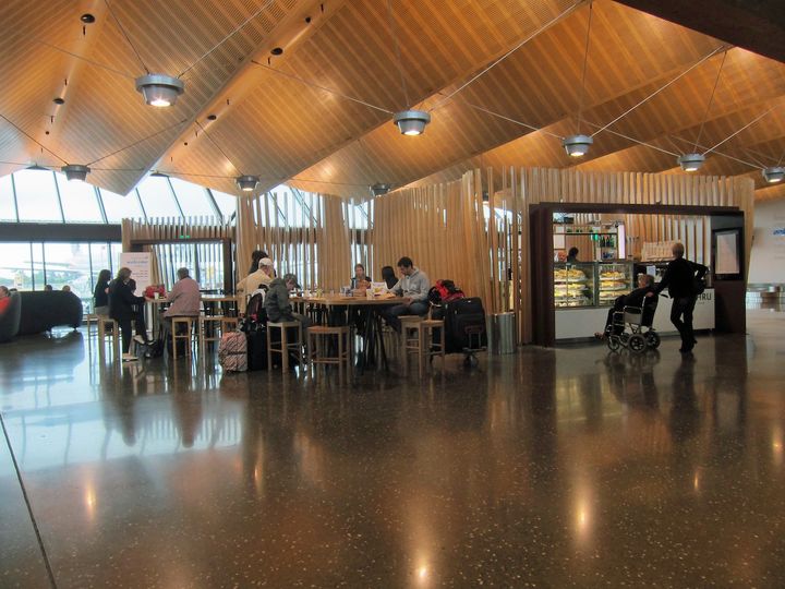 Koru Express is inside this island of vertical slats, with the food and drink area of the lounge on the other side of the public cafe.