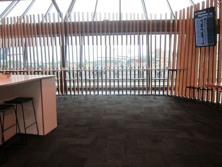 A better option is the long bench facing the windows and the tarmac.