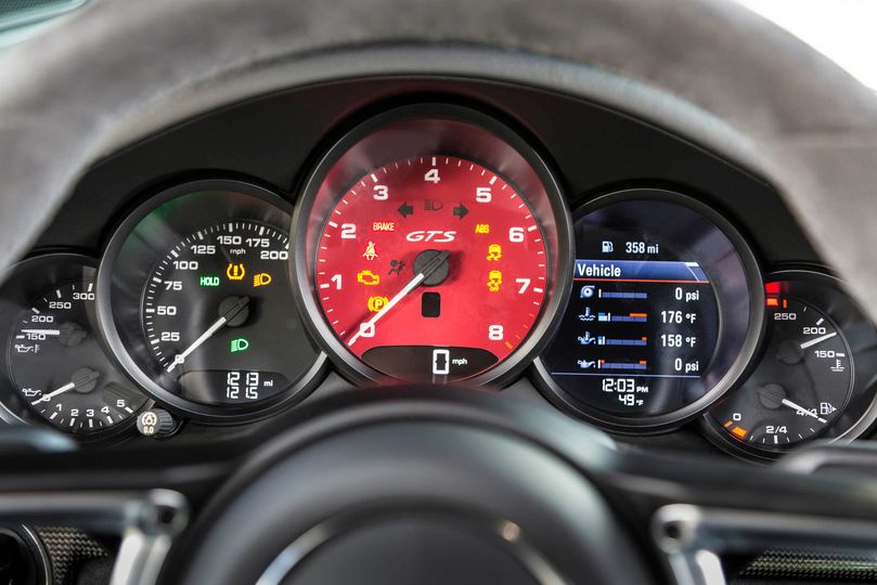 Porsche’s five-gauge instrument cluster with central tachometer is a signature look