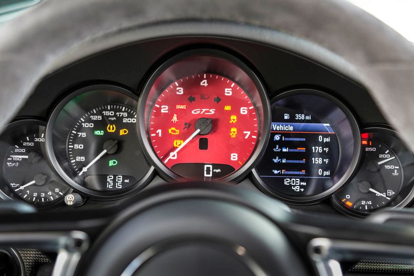 Porsche&rsquo;s five-gauge instrument cluster with central tachometer is a signature look