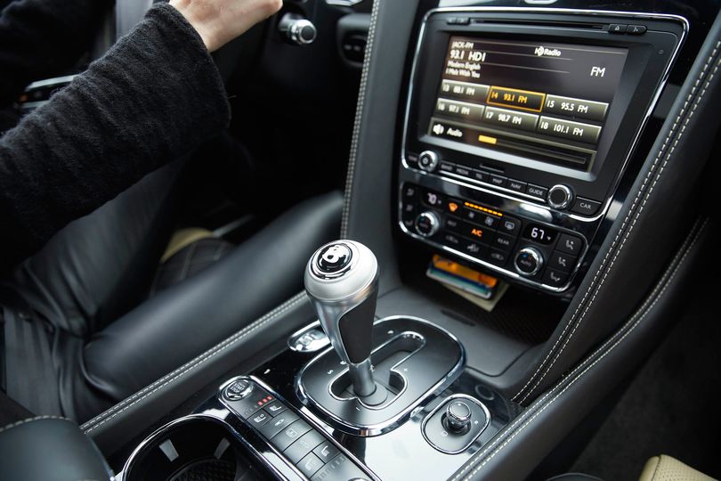 The shifter knob is not at the most convenient position for holding beverages or cell phones in the center console.