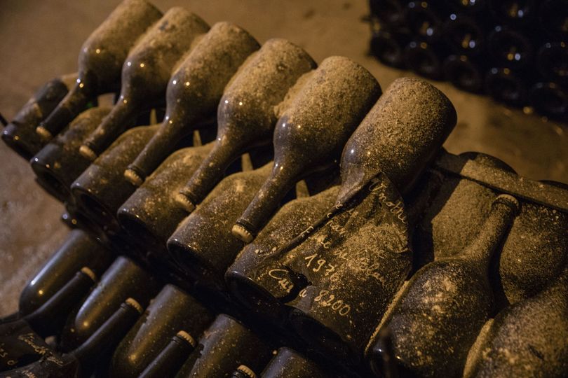 Dust rests on bottles of champagne inside the wine-maker's cellars.