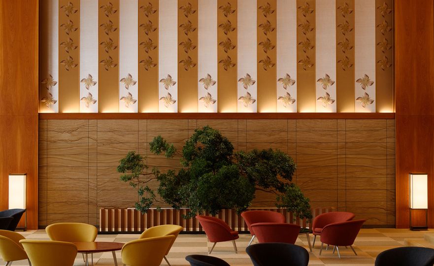 A pattern of four-petal flowers ornamental textile on the wall of the lobby.
