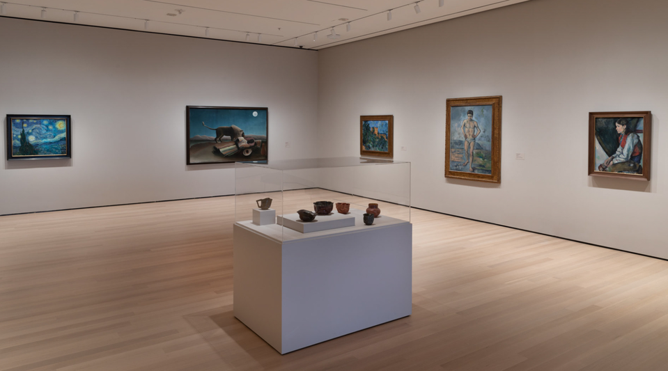 Pottery by George Ohr (foreground), with Vincent Van Gogh’s Starry Night, Henri Rousseau’s Sleeping Gypsy, and three paintings by Paul Cézanne.