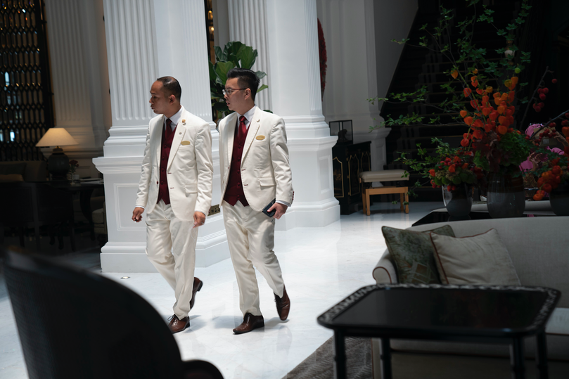 Striding through the newly renovated lobby, the staff members look almost as sharp as the hotel, with their suits, waistcoats and red neckties.
