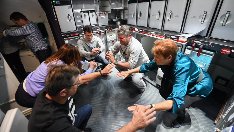 Passengers make use of every available space for stretching exercises.