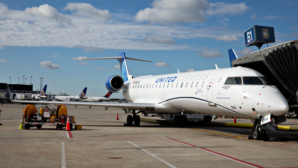 The United CRJ-550 sits at a gate at O'Hare International Airport.