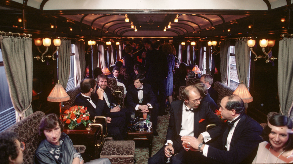 Guests relax in the lounge car on-board the Orient-Express from London to Venice in 1985.