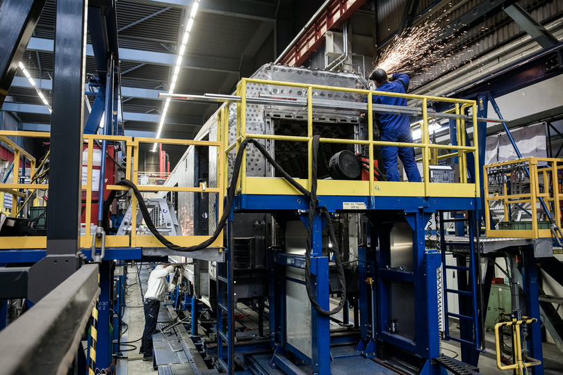 Workers fabricate rail carriages on the production line at the Siemens railway plant in Vienna.