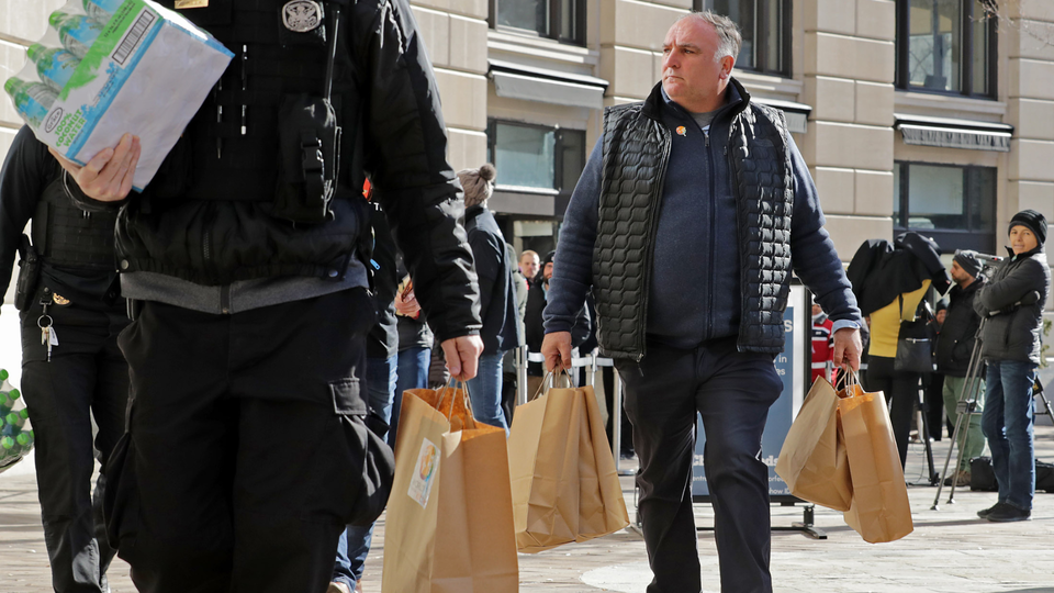 Chef José Andrés, right, carries meals for U.S. Park Police affected by the federal government shutdown.