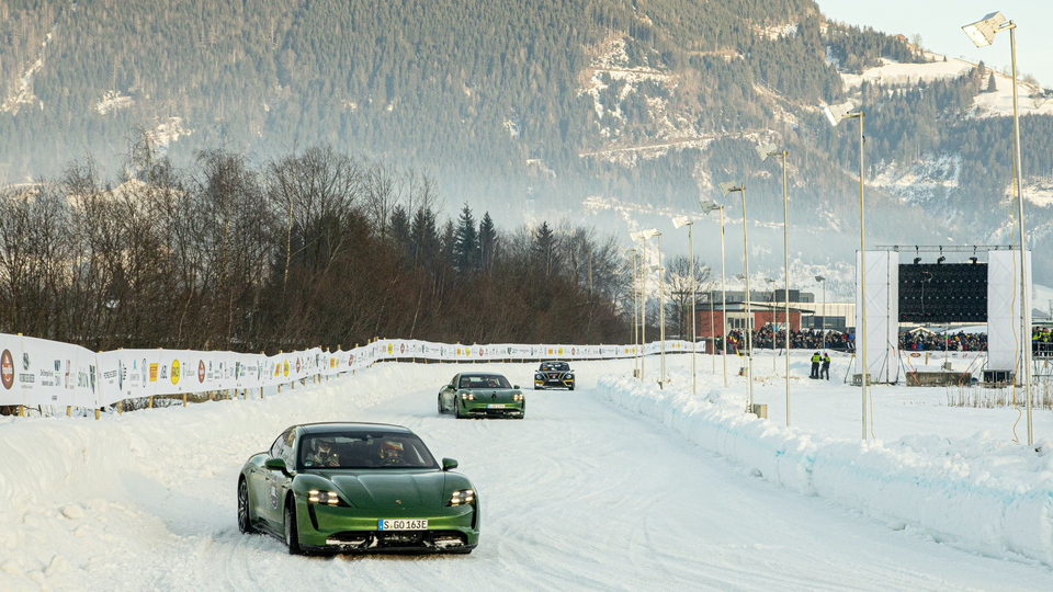 The latest Porsche Taycan Turbo S electric sports cars drift around the alpine track high in the Austrian Alps. Race emissions are being balanced out with green actions for the first time.