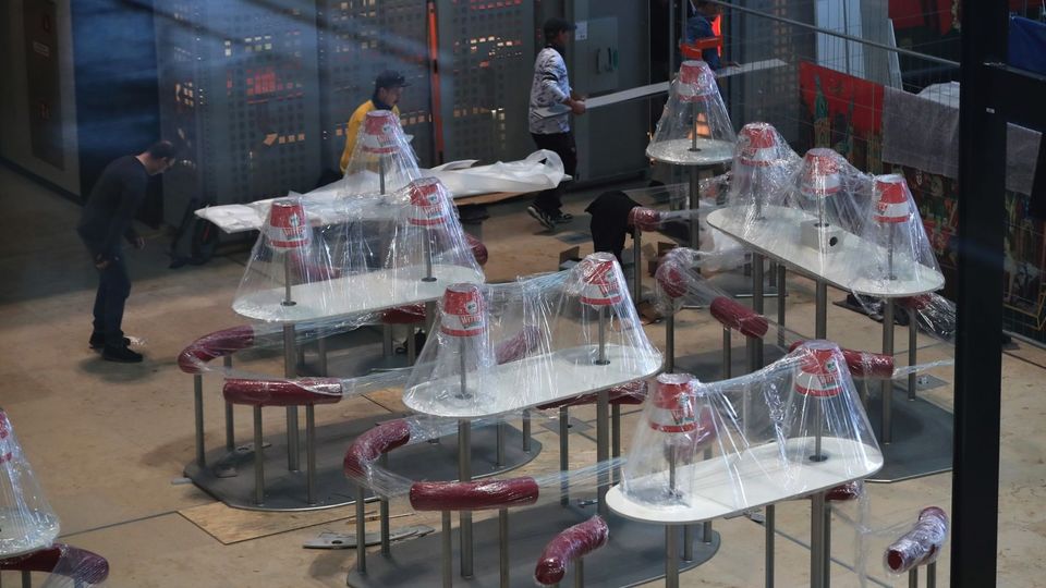 Plastic-covered dining tables in Terminal One’s food hall ahead of opening.