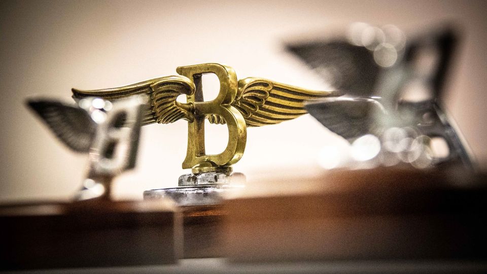 Charles Sykes first developed the Flying B in 1919. He also developed the Spirit of Ecstasy emblem for Rolls-Royce.