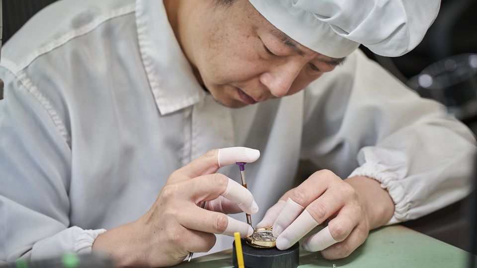 A watchmaker putting the final touches on a Grand Seiko 9SA51 movement.