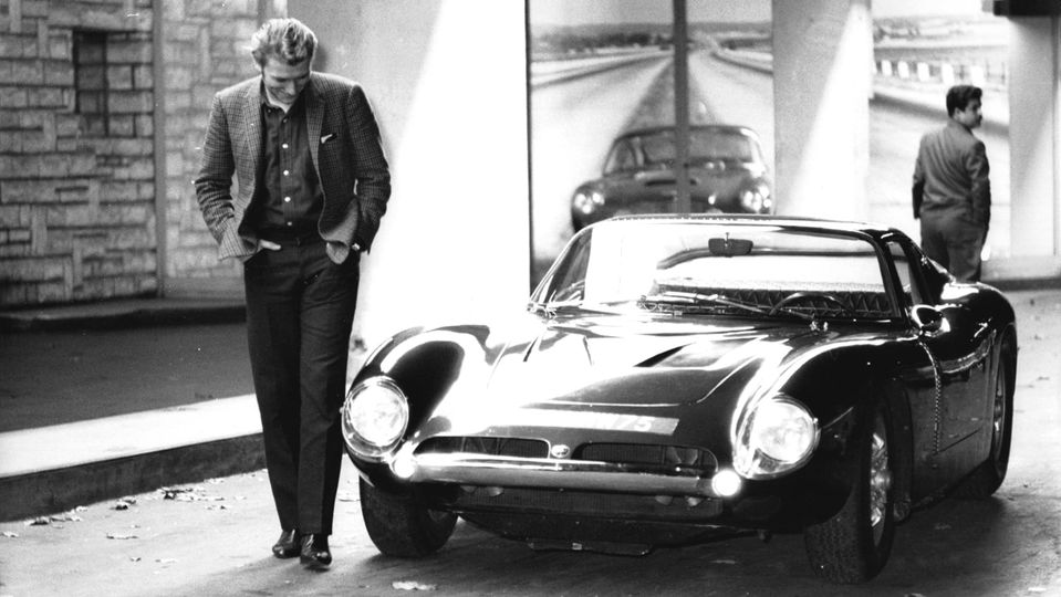 Singer Johnny Hallyday admires a Bizzarrini 5300 GT in Paris, circa 1960.