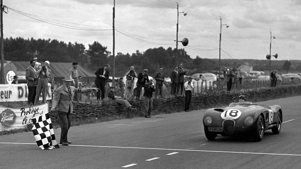The No. 18 Jaguar C-Type of Tony Rolt and Duncan Hamilton wins the 1953 Le Mans 24 Hours.