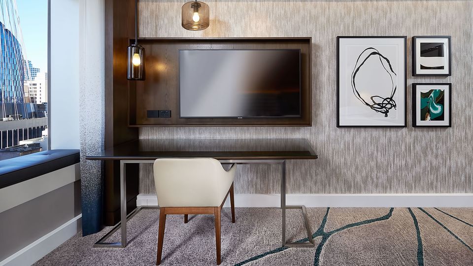 Smaller leather-wrapped seats replace ergonomic office chairs in all rooms and suites.