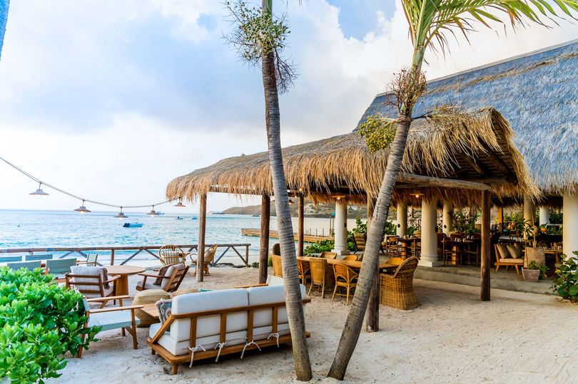 A toes-in-the-sand spot for happy hour at Soho Beach House Canuoan.