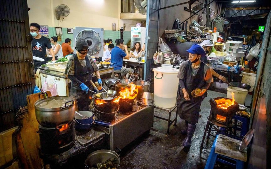 The Queen of Street Food, Michelin star chef Jay Fai prepares food at her restaurant in downtown Bangkok.