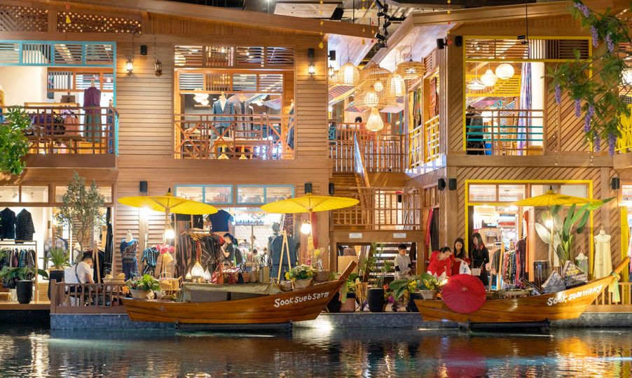 Shoppers walk past stores in the the SookSiam area inside the IconSiam megamall.