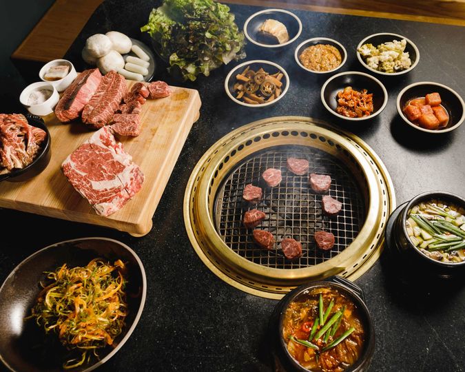 Beef is cooked in courses on the tabletop grill at Cote.
