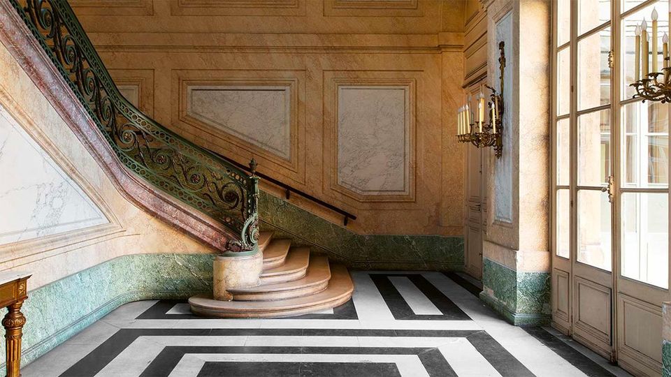 The main staircase includes a wrought-iron and bronze bannister by the ironsmith Claude Roche.