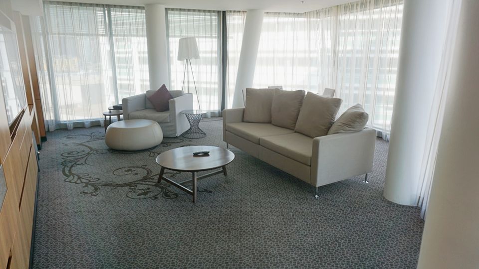 The large living room features a couch, executive armchair and dining space for four.