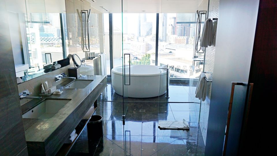 The bathroom is almost as big as the bedroom.