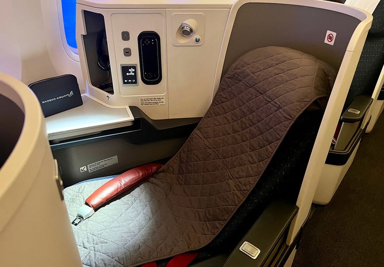 A quilted sleep cover was slipped over the seat when requested.