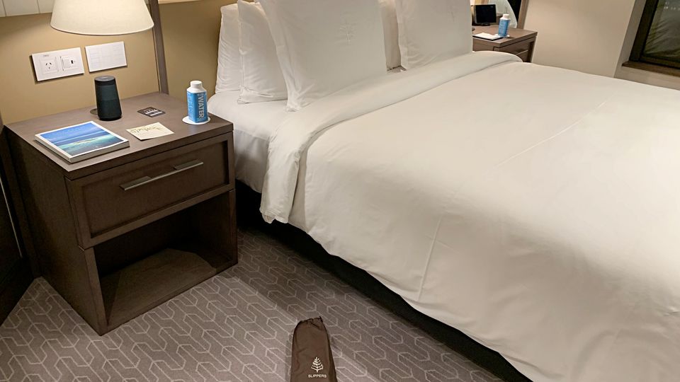 The hotel places its slippers right at the bed, not in the wardrobe.