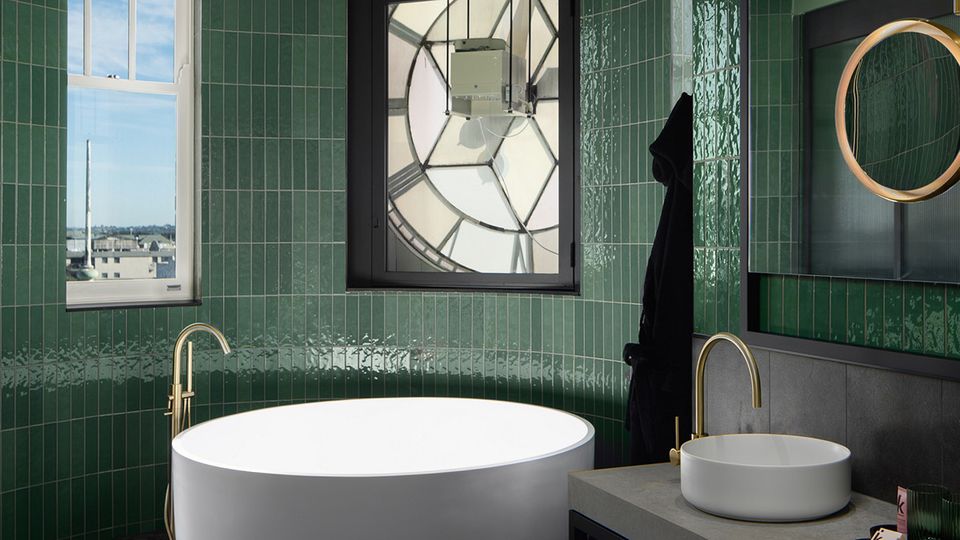 The restored clock face and mechanism take pride of place in the bathroom.