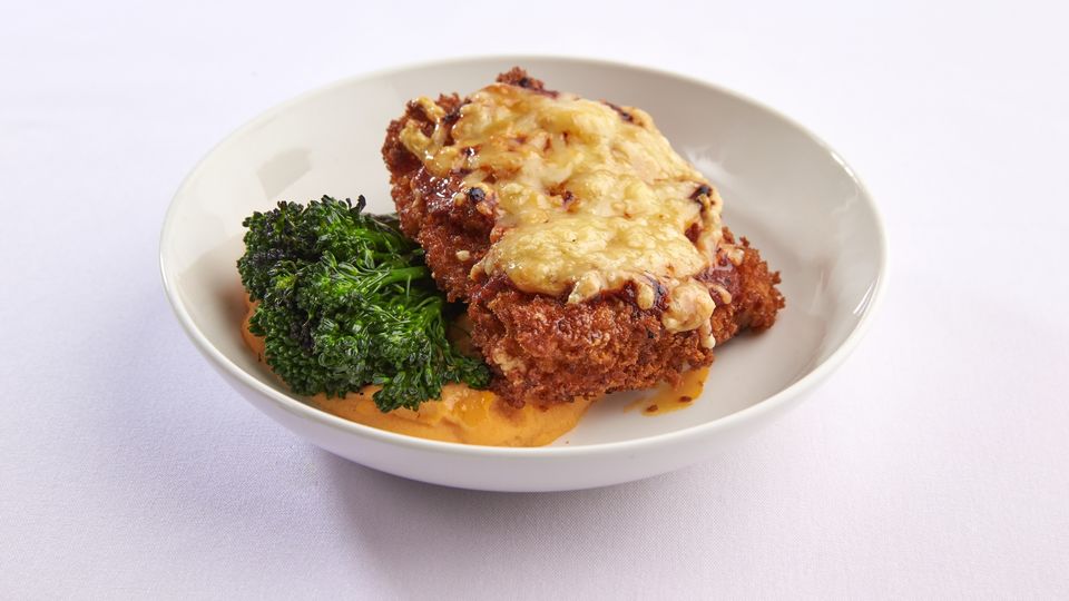 Chicken Parmigiana with mashed sweet potato and broccolini.