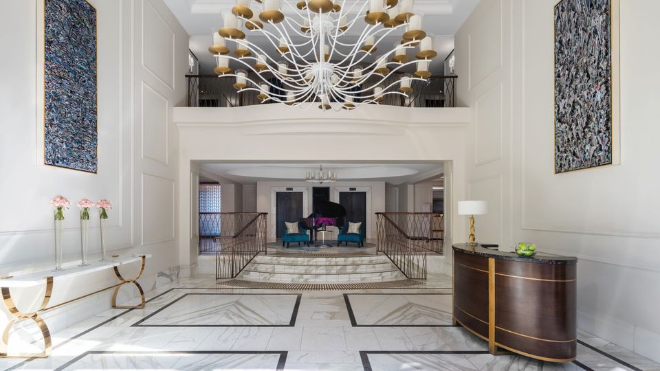 An impressive chandelier greets guests inside the front doors.