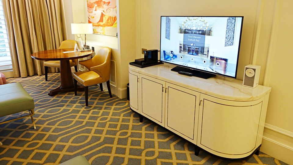 Room amenities included a large dining table and a marble television unit.