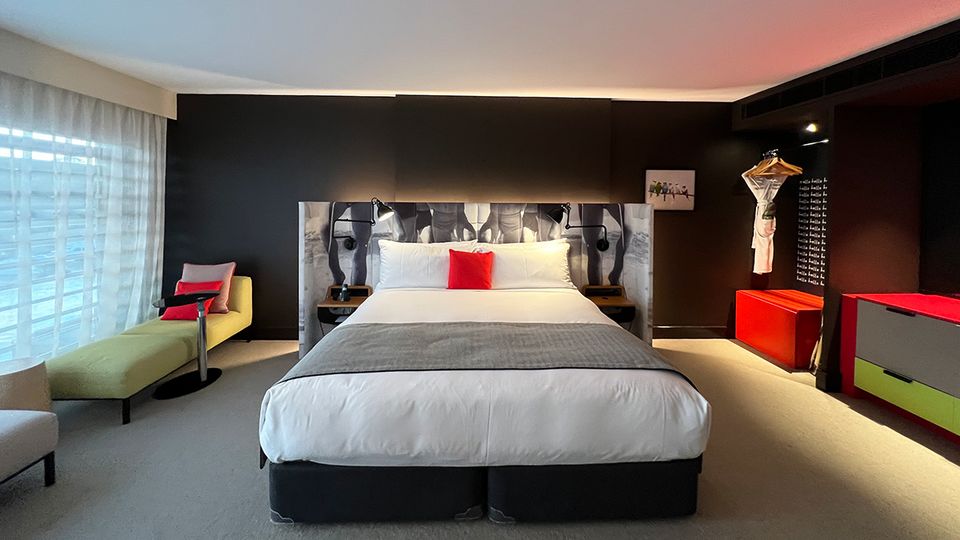 Quirky artworks and an upholstered bedhead dialled up the personalty of the room.