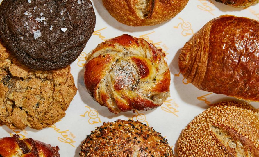A Smør bakery spread including the signature cardamom bun (center).